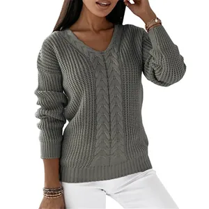 Macro view of detailed cable knit texture on a sage green V-neck sweater