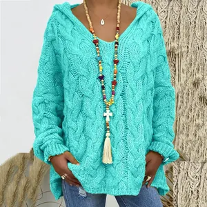 Detailed view of turquoise chunky knit hooded sweater featuring a textured cable pattern