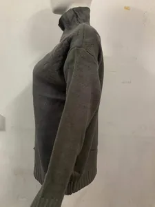 Side profile of a dark gray women's turtleneck long-sleeve chunky knit sweater on mannequin