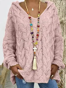Close-up detail of a pink cable-knit hooded V-neck sweater showing its thick knit texture