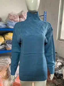 Detailed view of blue turtleneck long sleeve knitted sweater with texture on mannequin