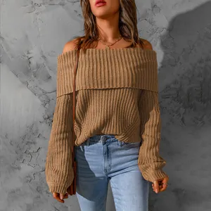 Detailed shot of an elegant brown off-the-shoulder chunky knit sweater for women.