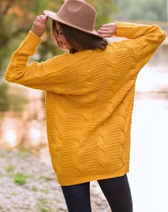 Vista trasera de una mujer con un jersey amarillo grueso de punto de ochos en otoño