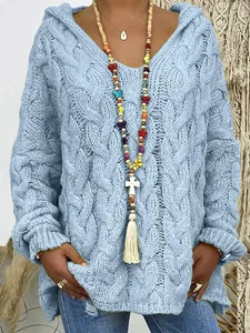 Detail of light blue cable-knit texture on a women's hooded V-neck loose sweater