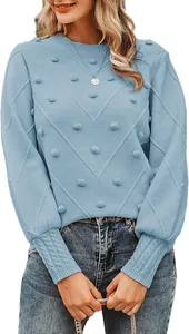 Close-up of light blue pom-pom knit sweater with diamond patterns and round neck