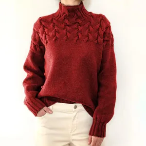 Nahaufnahme eines roten Damen-Rollkragenpullovers mit Zopfmuster und feiner Textur.