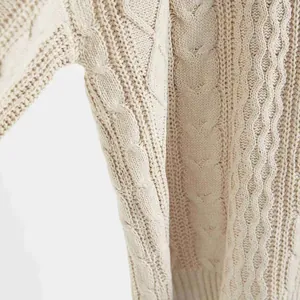 Detailaufnahme des filigranen Zopfmustermaterials eines weichen beigen Damenpullovers