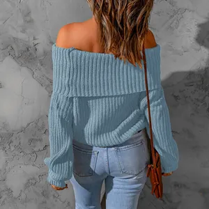 Back view of a blue off-the-shoulder knit sweater showing the ribbed texture and fold-over neckline