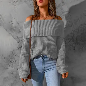 Detail of a grey off-the-shoulder knitted sweater with textured ribbing.