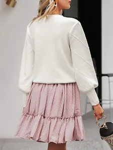 Back view of elegant white lantern sleeve knit sweater with textured diagonal patterns