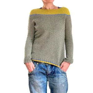 A detailed view of women's round neck color-block knit sweater in grey and yellow