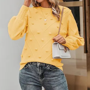 Elegant yellow crewneck knit sweater featuring playful pom-poms and V-pattern textures