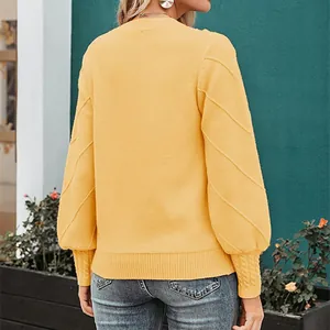 Rear view of an elegant yellow knit sweater with textured lantern sleeves.
