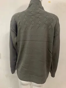 Close-up of the back of a gray knitted high-neck sweater with textured pattern