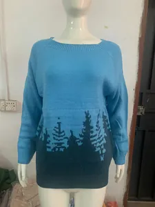 Detail view of women's blue and navy color block knitted sweater with pine tree patterns