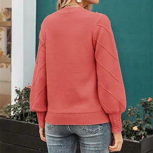 Back view of elegant coral pink long sleeve knitted sweater with textured sleeves.