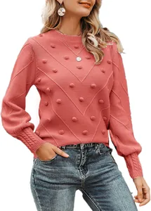 Close-up detail of elegant pink pom-pom crew neck sweater with puff sleeves for women