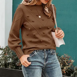 Detailed view of a brown bobble knit sweater featuring an elegant round neck design