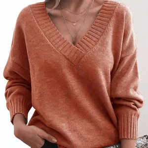 Close-up detail of a women's loose V-neck knitted sweater in elegant burnt orange