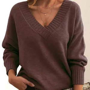 Close-up detail of women's loose V-neck knitted pullover sweater in brown color