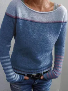 Close-up of a blue color block knitted sweater featuring striped sleeve details
