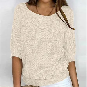 Detail showing texture of elegant cream round neck knit top with 3/4 sleeves