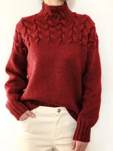 Elegant red turtleneck cable knit sweater for women with a cozy loose fit silhouette