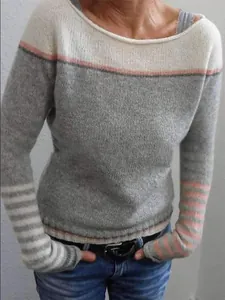 Close-up of stylish women's color-block sweater with pink and gray knit stripes