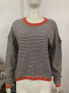 Close-up of a striped knit sweater featuring orange contrast trim and drop shoulders