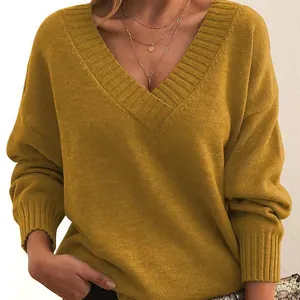 Close-up detail of mustard yellow V-neck oversized casual knit pullover sweater