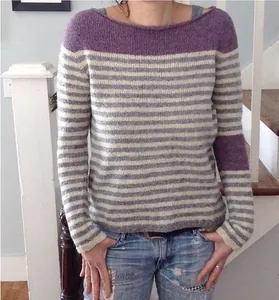 Detail shot of women's color-block striped sweater with purple accents and loose fit