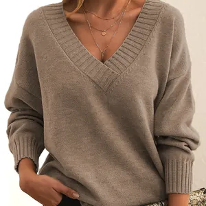 Detailed view of the oversized V-neck knit sweater featuring soft brown textured fabric