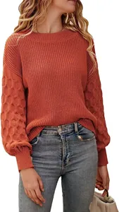 Macro view of a burnt orange knit sweater featuring distinctive lantern sleeve texture details