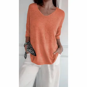 Detail of a casual women's orange V-neck knit sweater featuring stylish 3/4 sleeves