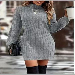 Outdoor lifestyle shot of a grey turtleneck knitted sweater dress with ribbed texture.