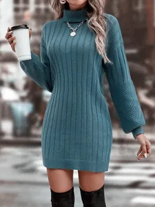 Detail of a teal turtleneck ribbed knit sweater dress featuring stylish lantern sleeves