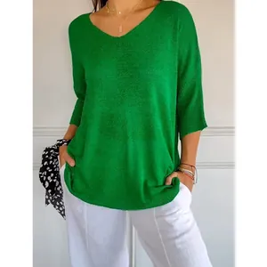 Casual women's green V-neck knitted sweater with three-quarter sleeves in a lifestyle setting.
