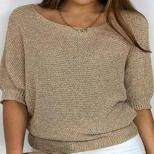 Elegant women's golden knit sweater featuring a classic round neck and stylish three-quarter sleeves