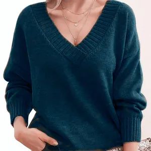 Detail view of a soft dark teal women's loose knit sweater featuring a ribbed V-neckline