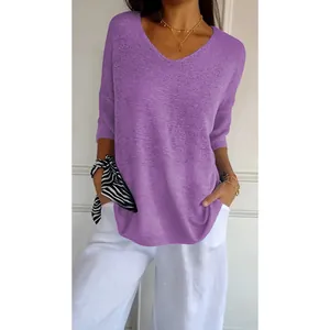 Detail view of a purple V-neck knitted top with 3/4 sleeves and a soft casual texture