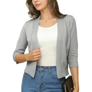 Detail view of an elegant grey short-knit cardigan with 3/4 sleeves for stylish women