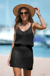 Detail view of stylish black sleeveless crochet vacation dress with waist cinching.