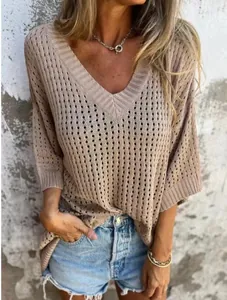 Detail of a casual V-neck hollow-out knit sweater featuring a relaxed bohemian style