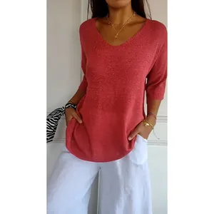 Detail showing the red V-neck knitted sweater with 3/4 sleeves and comfortable fit.