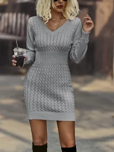 Close-up of grey cable-knit sweater dress with V-neck and slim waist design.