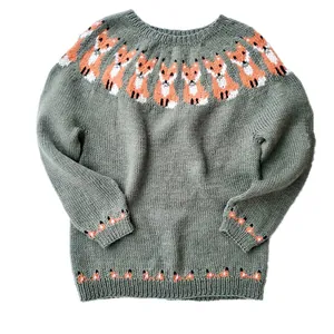 Close-up detail of women's round neck knit sweater with cute fox jacquard pattern in grey green