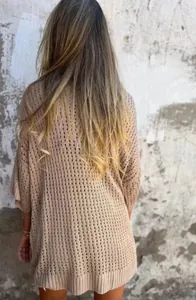 Detailed back view of a beige hollow-out knit cardigan in a relaxed, oversized style.