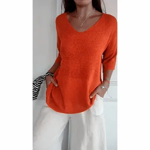 Detailed view of a casual orange V-neck knit sweater with stylish three-quarter sleeves