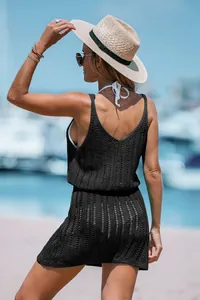 Back view of black knitted hollow out sleeveless resort dress with waist detail