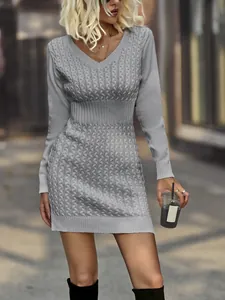 Detailed view of an elegant grey V-neck cable knit dress with a slim-fit ribbed waist